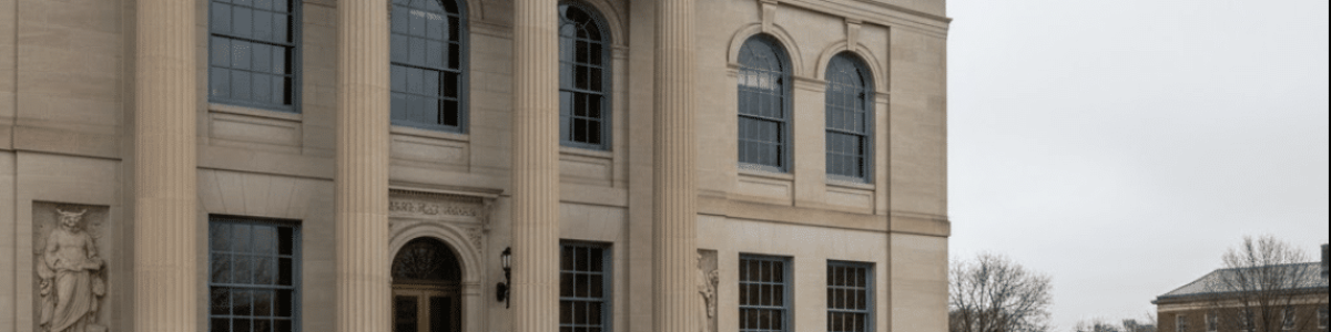 Classical academic building with columns and the inscription LEX ET DOCTRINA symbolizing the role of a Title IX lawyer in balancing law and education in New Jersey.